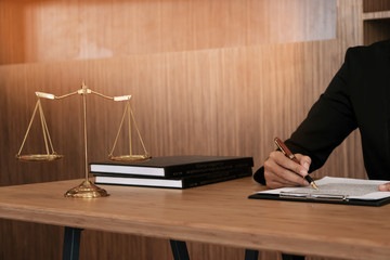 Legal counsel presents to the client a signed contract with gavel and legal law. justice and lawyer...