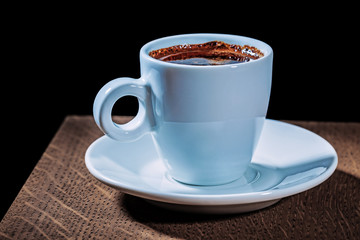 espresso in white coffee cup on vintage wood board