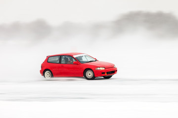 Fototapeta na wymiar Red car at ice racing