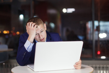 Businessman working at the table with a desk lamp.