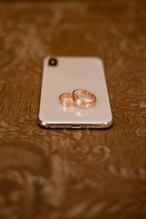 gold wedding rings are on the phone