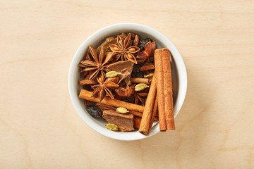 Spice for tea, coffe, baking in bowl on wooden table. 