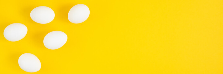 White eggs on yellow background. Photo 3: 1 with a place under the inscription, copy space