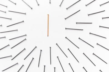 One golden nail surrounded by group of metal ones