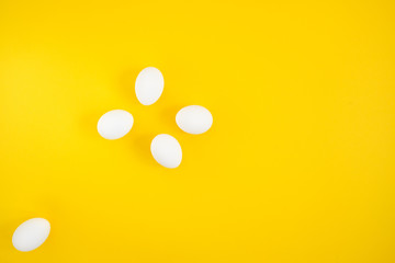 White eggs on yellow background