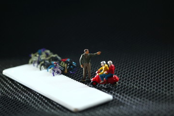 Old and dirty miniature plastic figure model toy of man riding motorcycle scene.