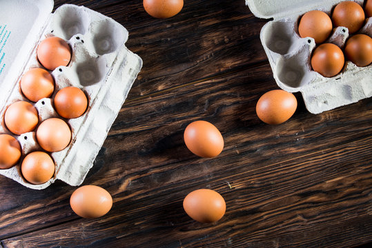 Chicken eggs are in the tray. Fresh chicken eggs in a tray on a rustic wooden table