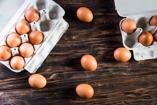 Chicken eggs are in the tray. Fresh chicken eggs in a tray on a rustic wooden table