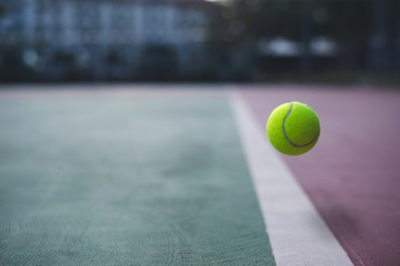 Close up tennis ball on the court background with copy space