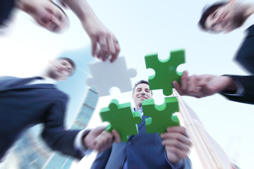 Business people assembling jigsaw puzzle