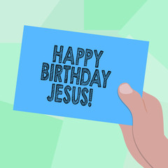 Conceptual hand writing showing Happy Birthday Jesus. Business photo showcasing Celebrating the birth of the holy God Christmas Day Drawn Hu analysis Hand Holding Blank Color Paper Cardboard