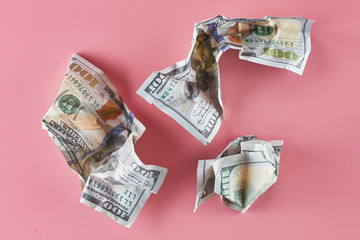 Dollars. Crumpled American money on a pink background