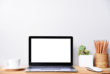 blank screen Modern laptop computer with mouse and Succulent on wood table in office view backgrounds