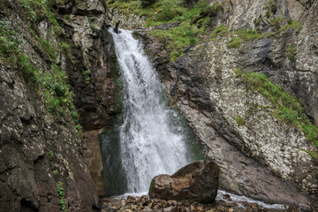 Fototapeta na wymiar Closeup view waterfall scenes in mountains, national park Caucasus, Russia