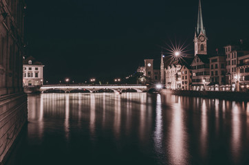Fototapeta na wymiar Night view of historic Zurich city center with famous Fraumunster Church