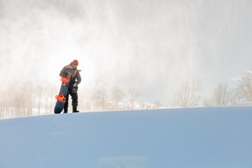 pleasant guy in sportswear preparing to go skateboarding. copy space. preparation for descend, freedom.