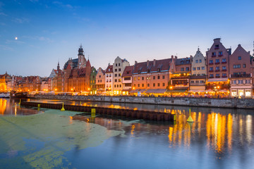 Old town of Gdansk reflected in Motlawa river at dusk, Poland