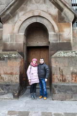 Fototapeta na wymiar Couple posing on Etchmiadzin Cathedral background