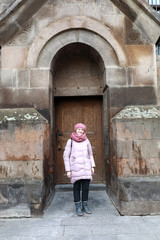 Fototapeta na wymiar Woman posing on Etchmiadzin Cathedral background