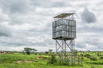 View with typical tropical landscape with a metal watchtower structure