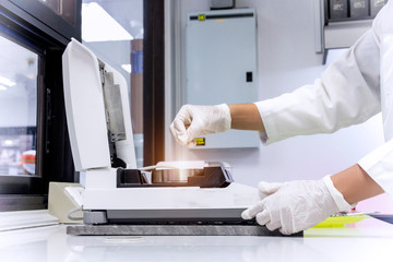 Chemist is testing the sample to measure %moisture by moisture balance in chemical laboratory.