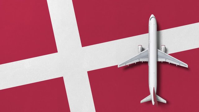 Airplane on the flag of Denmark. Flights related conceptual 3D animation 