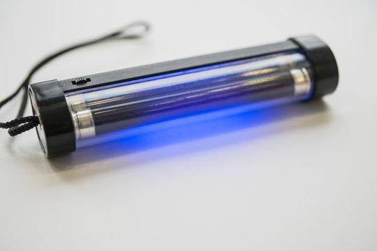 Manual UV lamp with batteries in working condition. Selective focus. Copy space.