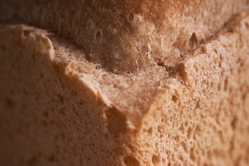 Top view of wholegrain bread on dark ructic wooden background closeup