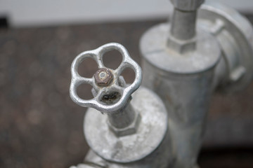 Metal stopcock on a construction site on the road