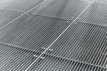 Steel metal grates cover industrial equipment.