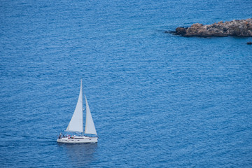 Sailing boat seen from Aphrodite trail, Akamas peninsula, Cyprus