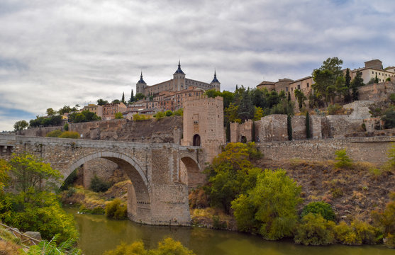 Alcantara bridge and view of the historic city of Toledo, Spain