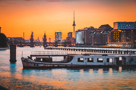 Berlin skyline with old ship wreck in Spree river at sunset, Germany