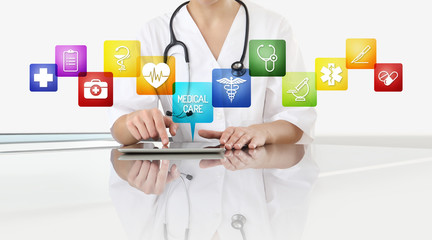hands of doctor woman touch digital tablet at office desk with medical symbols icons isolated on...