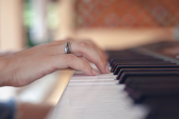Female hands on the piano keyboard, music education art concept, soft focus image