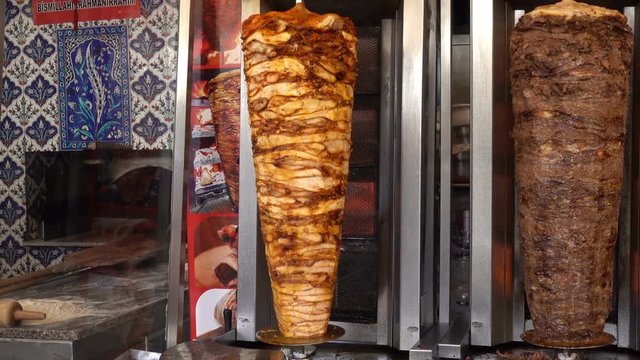Cooking shawarma. Big shawarma skewers spin in the kitchen. HD video