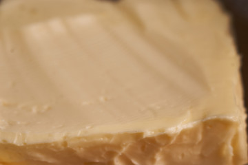 Pat of fresh farm butter close up macro Morning breakfast. selective focus