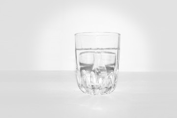 Drink water glass over sunlight on a white background 