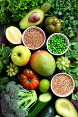 Clean eating selection Protein source for vegetarian: avocado, apple, broccoli, spinach, green peans on dark background. Healthy green food. Top view with copy space. Diet food.