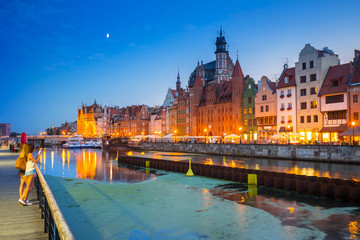 Fototapeta premium Old town of Gdansk reflected in Motlawa river at dusk, Poland