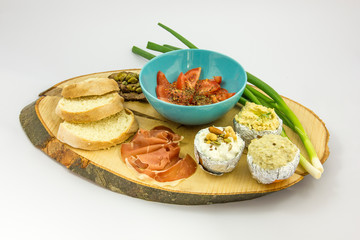 Cream cheese with seeds, eggplant, humus, green onions, tomatoes, beef, prosciutto capers