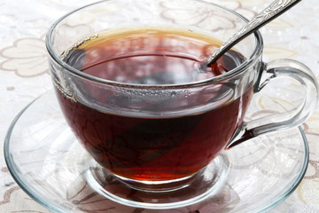 a mug of black tea is on the table
