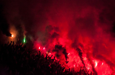 Football soccer fans lit up the lights, flares and smoke bombs. Protest concept.
