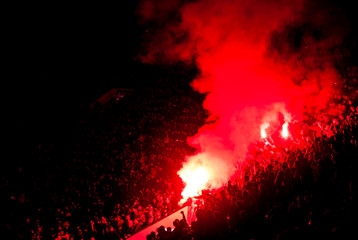 Fototapeta na wymiar Football fans lit up the lights, flares and smoke bombs. Protest concept.