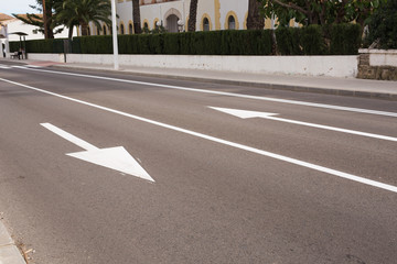 Arrow signs as road markings on a street with two lanes
