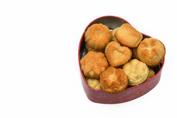 Isolate. Valentine's day. The heart-shaped box has a lot of cupcakes, cookies. Horizontal photography.
