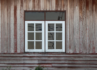 White color windows and old brown color wooden wall.
