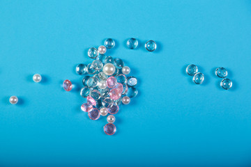 A scattering of white and pink stones on a blue background.