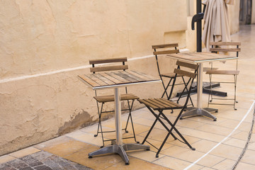 Cafe, coffee shop, tavern and restaurant concept - Outdoor street cafe tables ready for service.