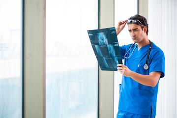 Young handsome doctor working in the hospital 